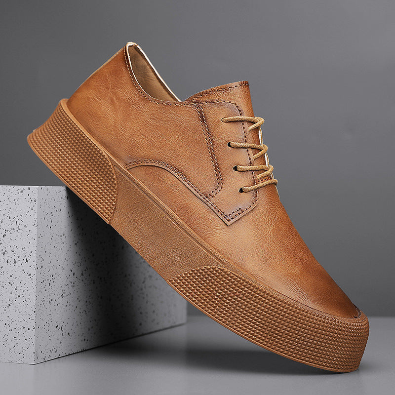 Brown leather shoe on a gray background