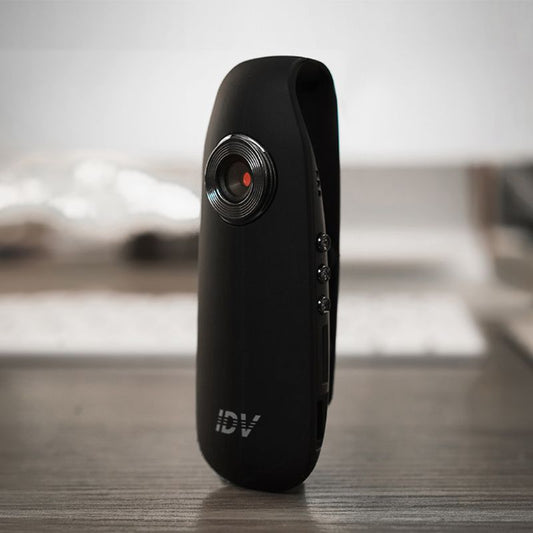 Black camera device with 'IDV' branding on a wooden surface