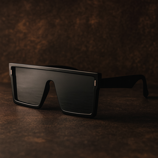 Black sunglasses on a textured brown surface