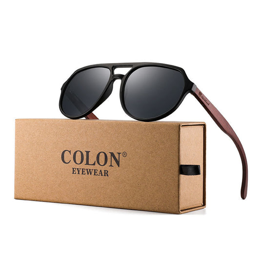 Sunglasses with brown frame and dark lenses on a Colon Eyewear box.