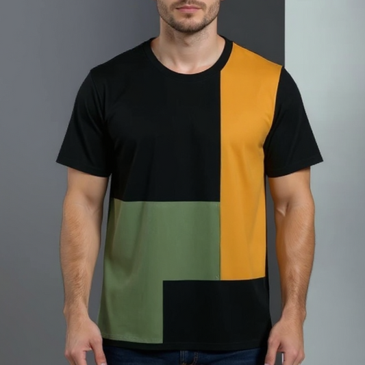 Man wearing a black, mustard yellow, and green color-blocked t-shirt against a gray background