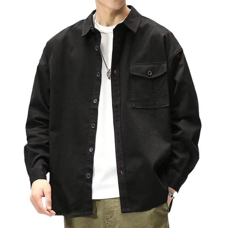 Person wearing a black jacket over a white shirt on a white background